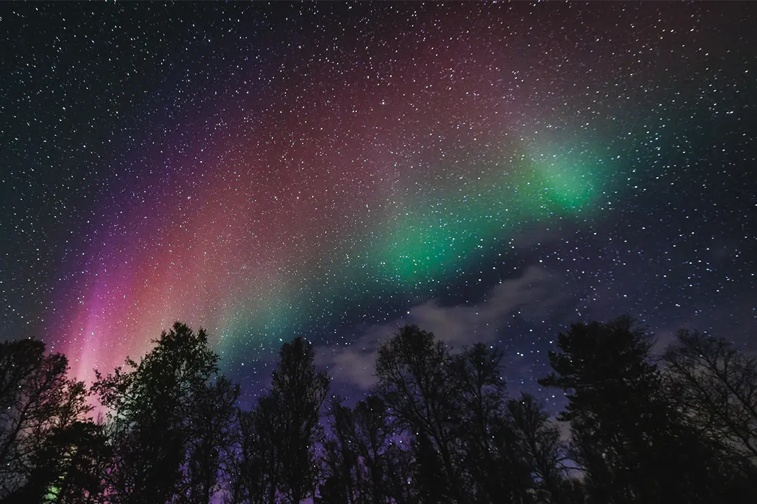 Northern Lights rainbow in the starry sky